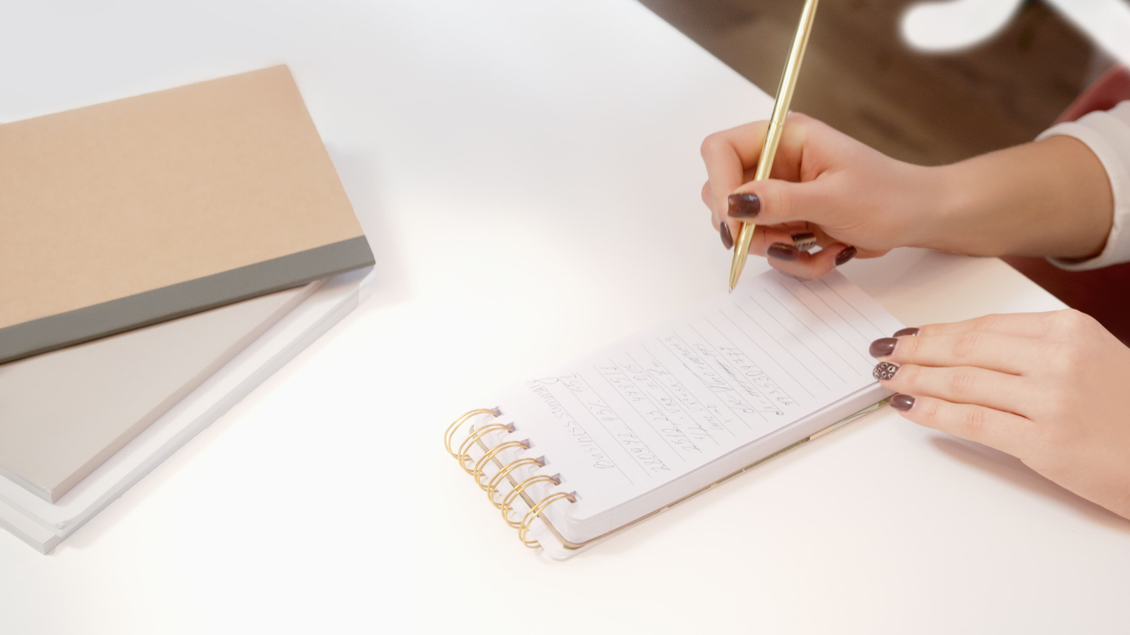 A notebook and pen on a desk, mid-sentence.