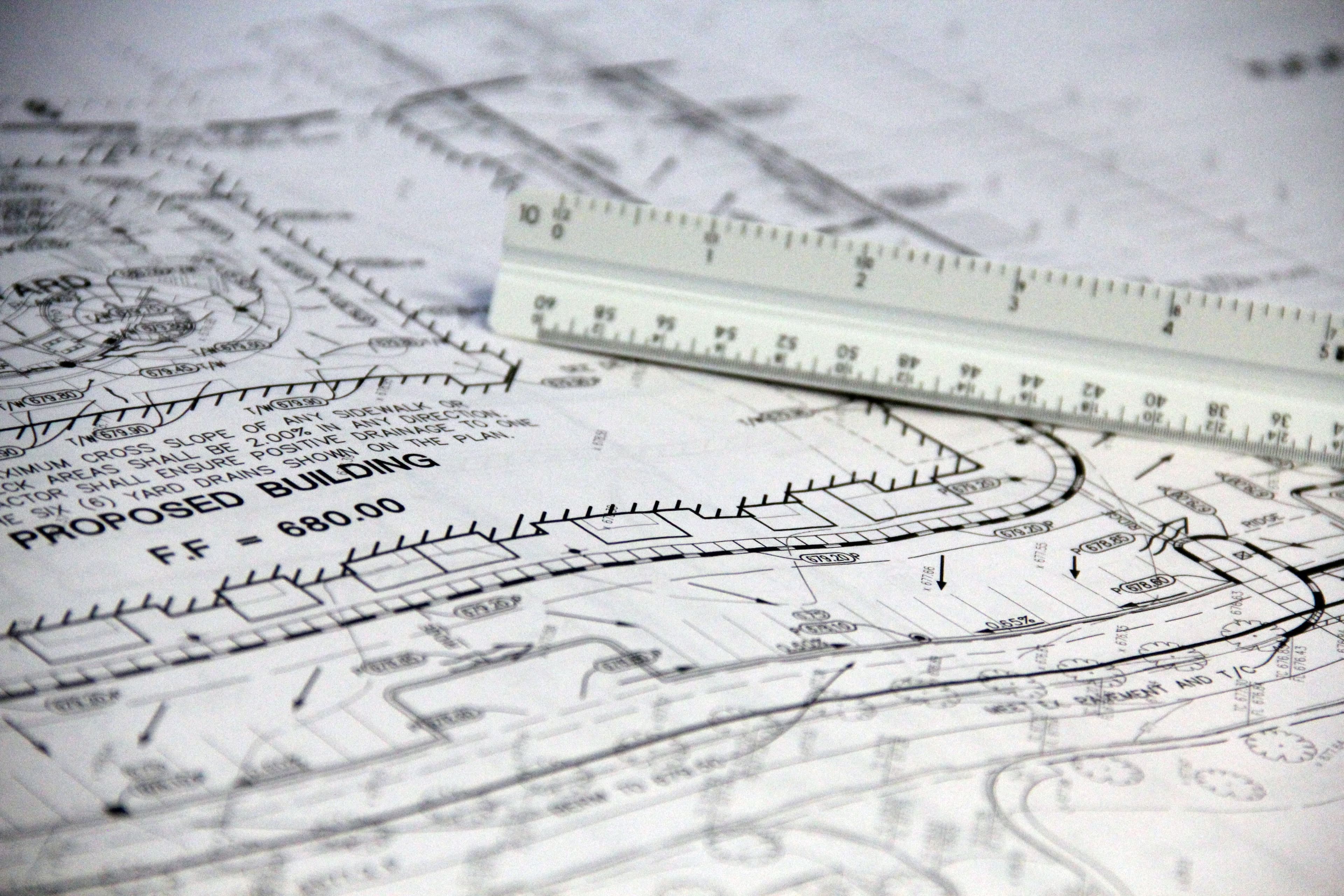 Technical drawing tools laid out on gridded paper.