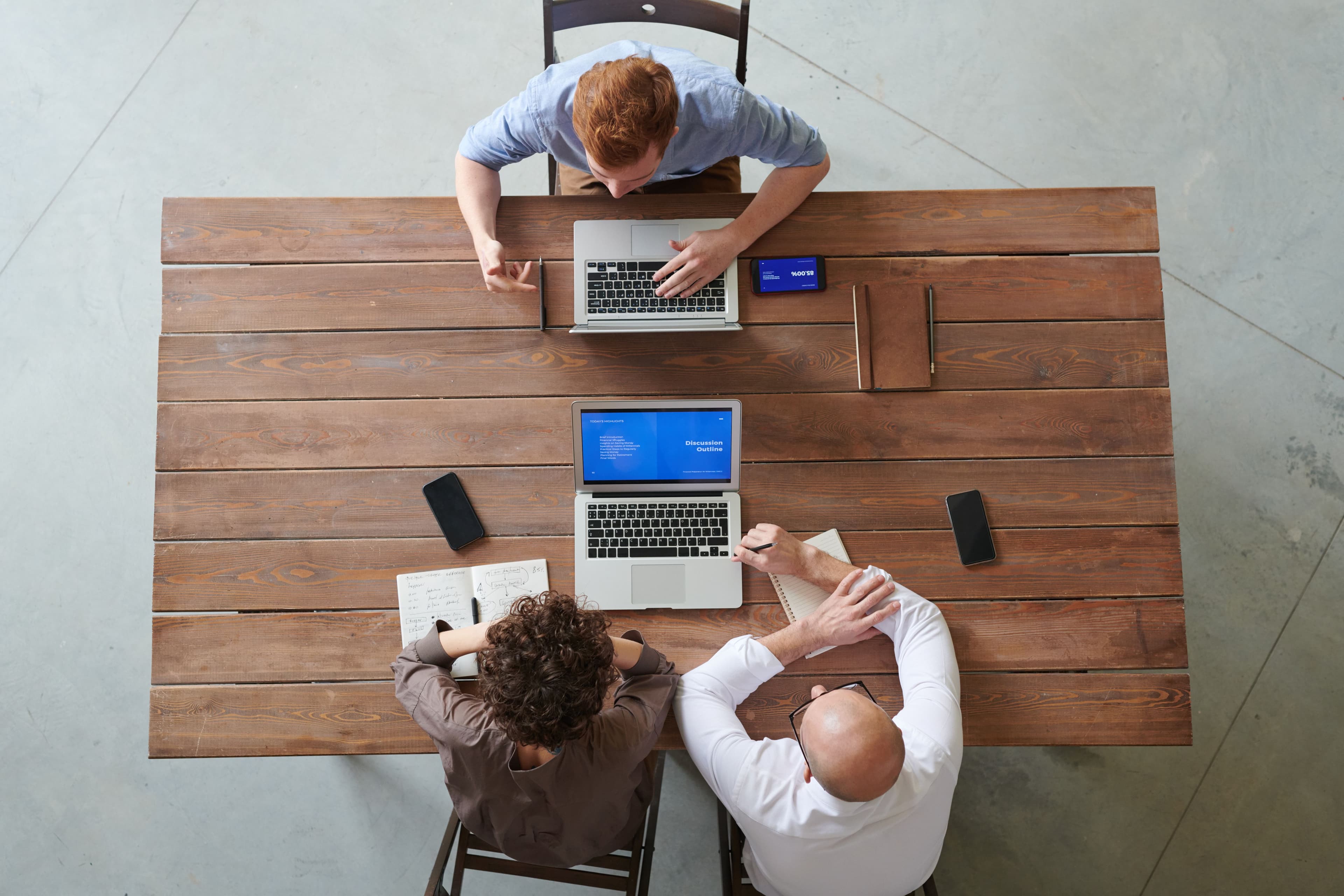 Two people working through a problem together at a laptop.