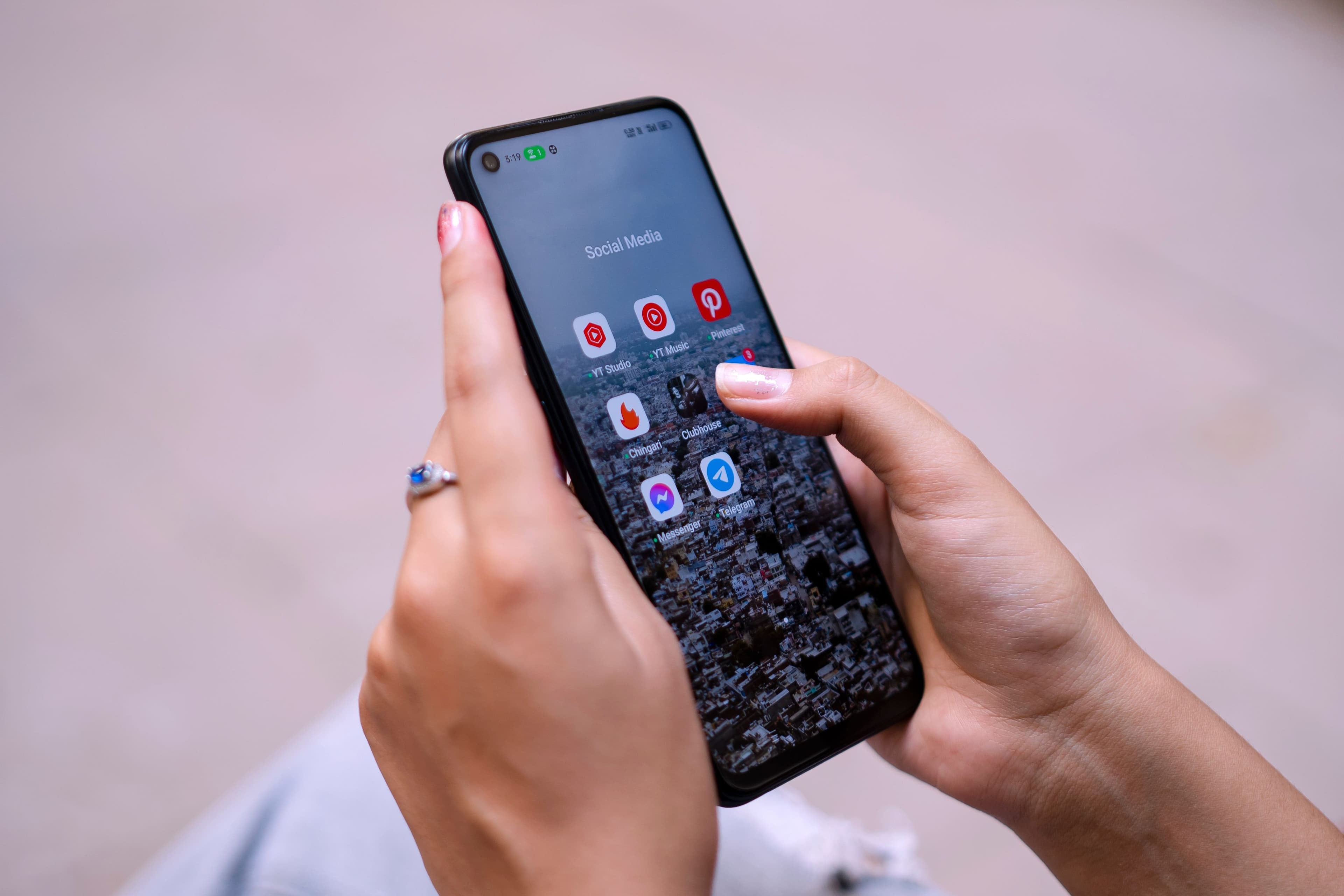 A phone held in one hand, app open.